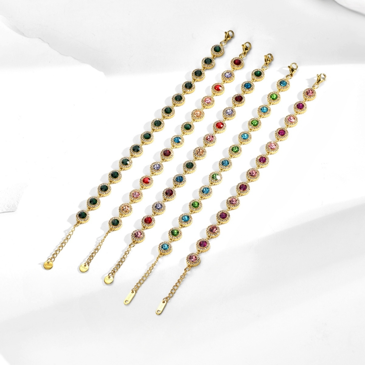 Gold Tennis Bracelet detail showing green, pink, blue, red and multicolor crystal options