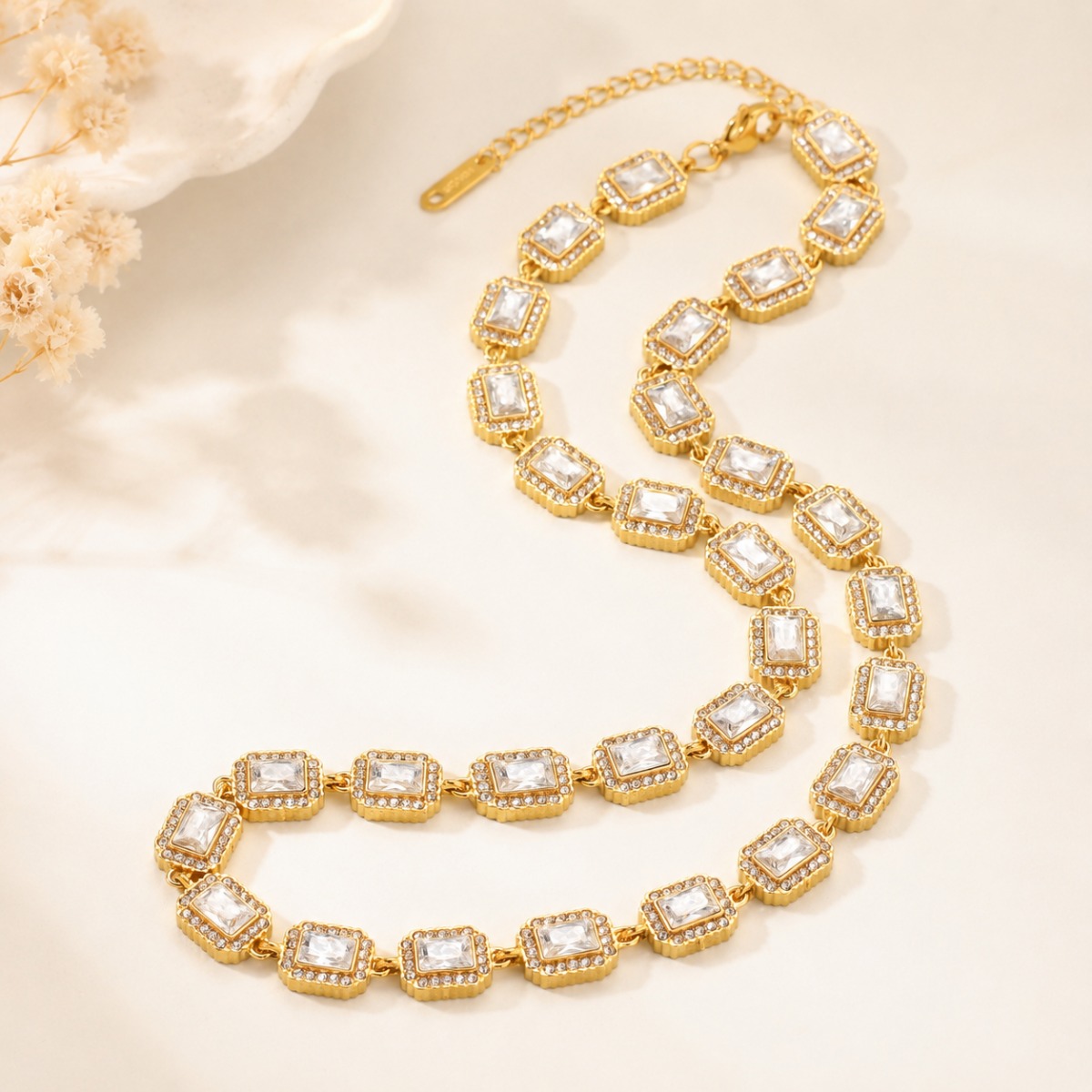 Rectangular crystal tennis necklace displayed in a light jewelry scene