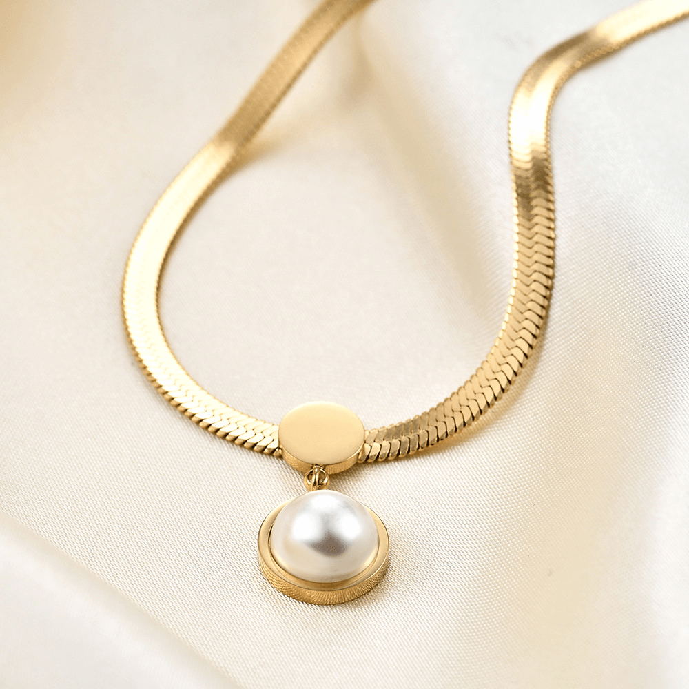 Pearl pendant snake chain necklace displayed in a light jewelry scene