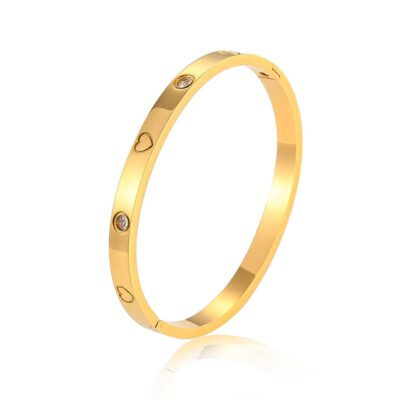 gold crystal heart bangle on white background