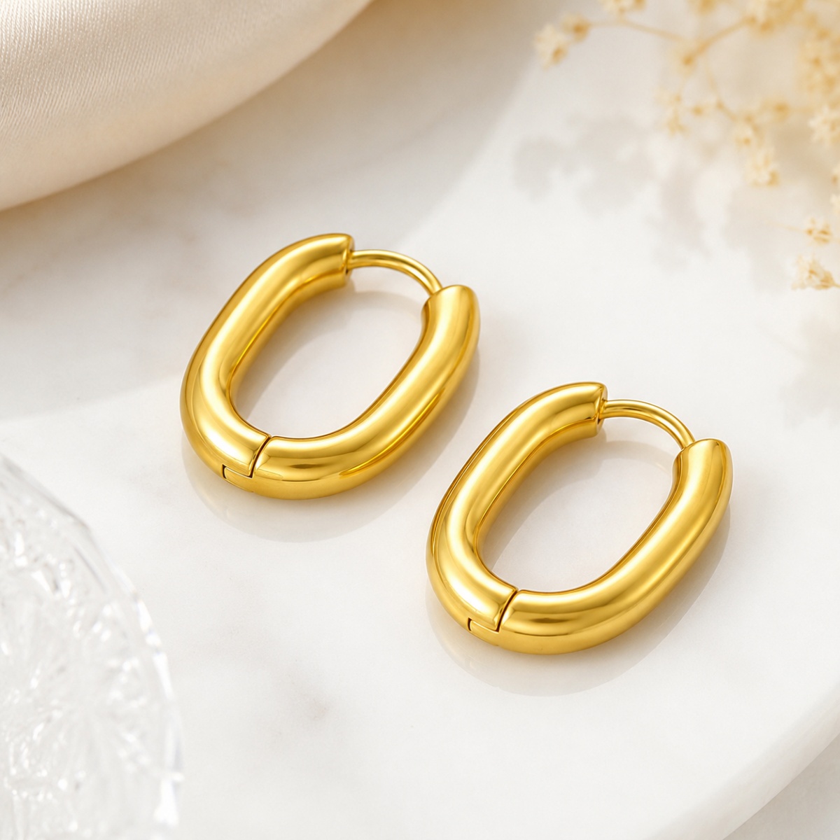 gold chunky hoop earrings on white background