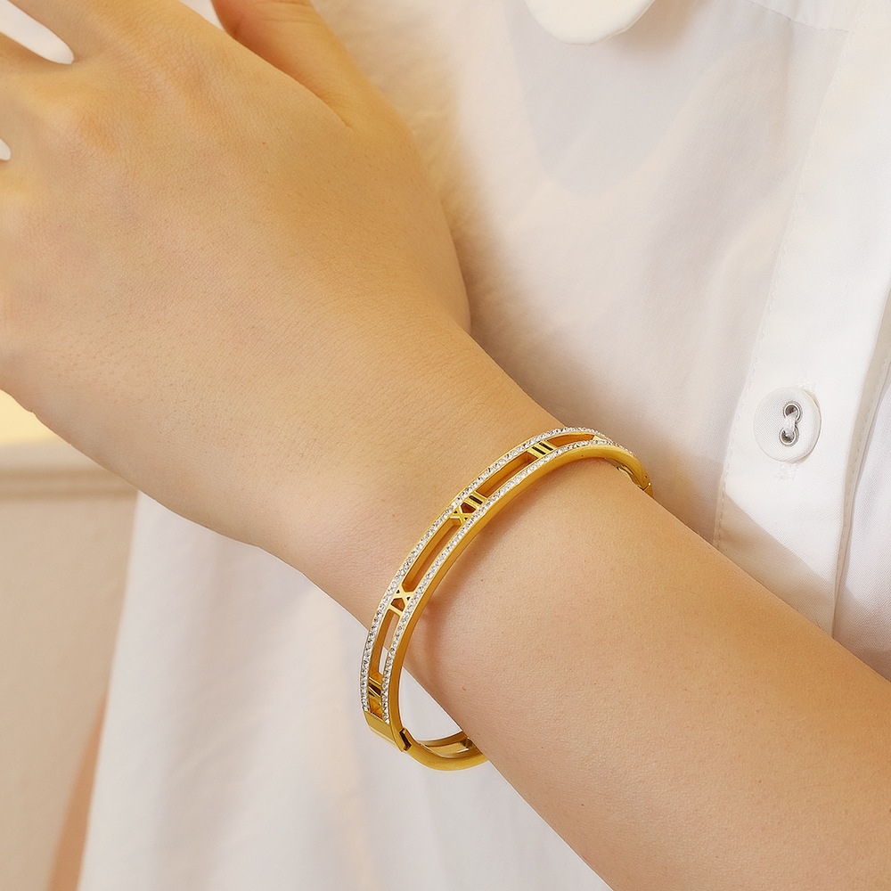 gold crystal roman bangle on white background