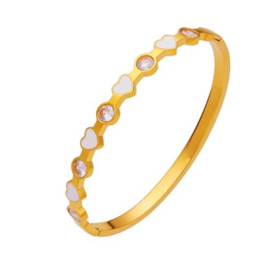 gold heart & crystal bangle on white background