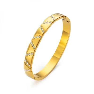 Gold stainless steel crystal bangle on white background