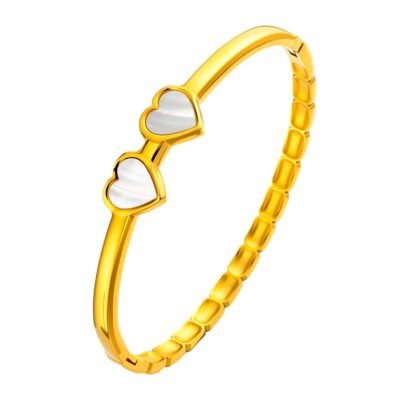 Gold stainless steel heart bangle on white background