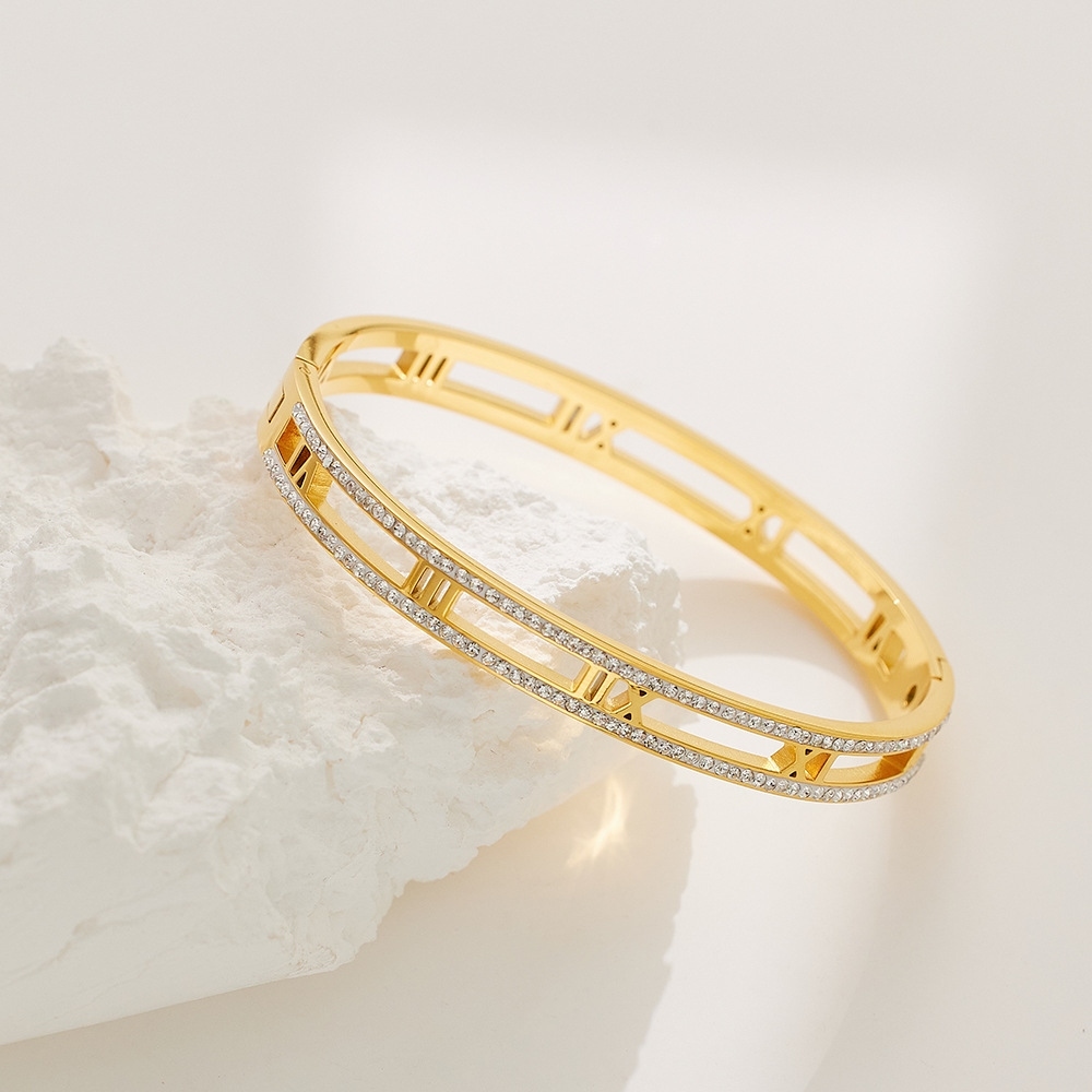 gold crystal roman bangle on white background