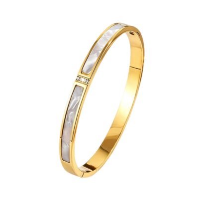 Gold stainless steel mother of pearl bangle on white background