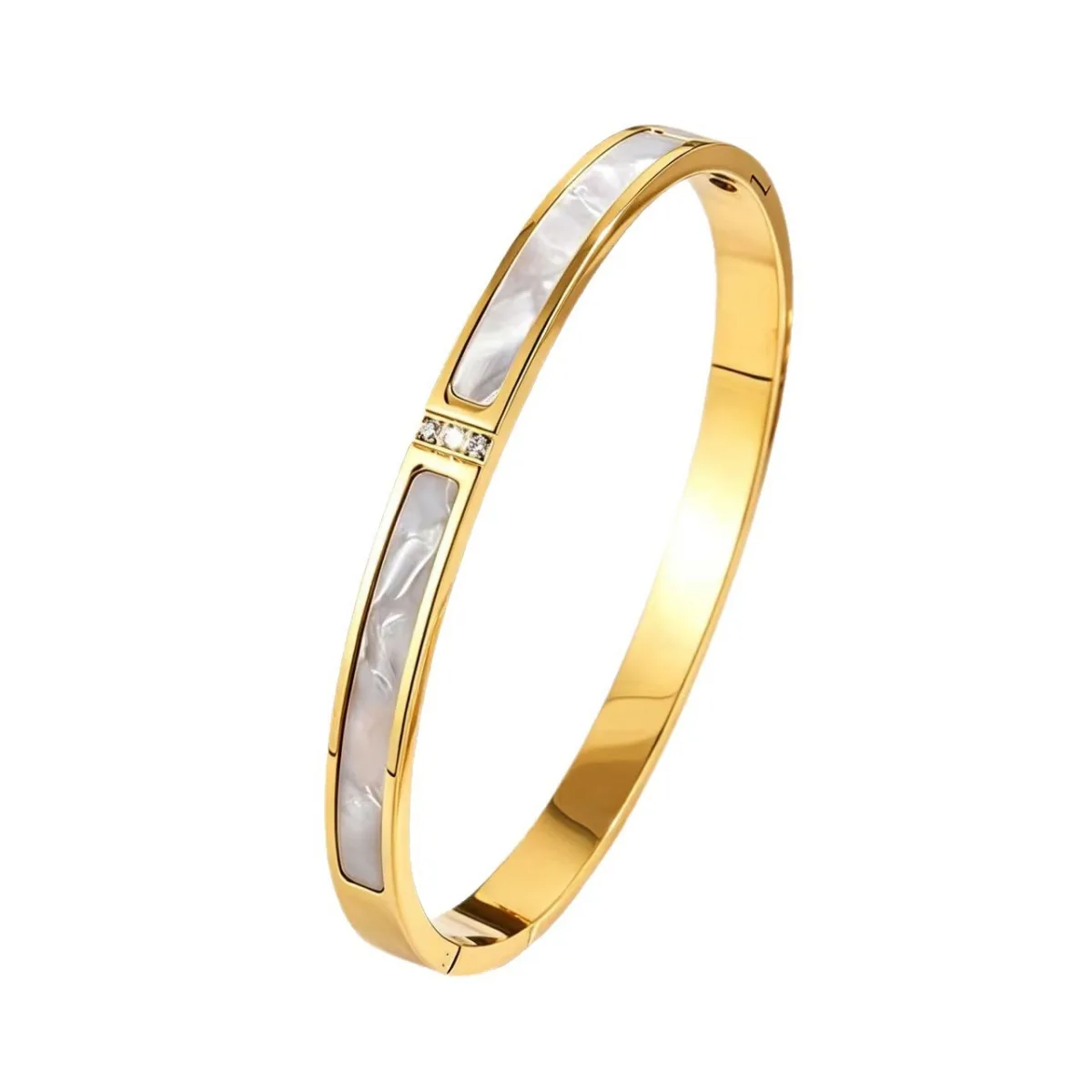 Gold stainless steel mother of pearl bangle on white background