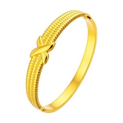 Gold stainless steel knot bangle on white background