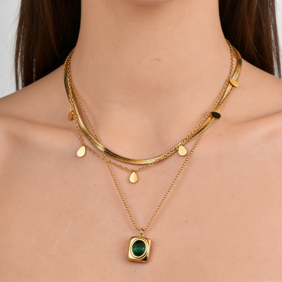 Model wearing a gold plated layered green stone pendant necklace